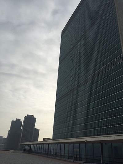 Photo of building outside with a cloudy sky.